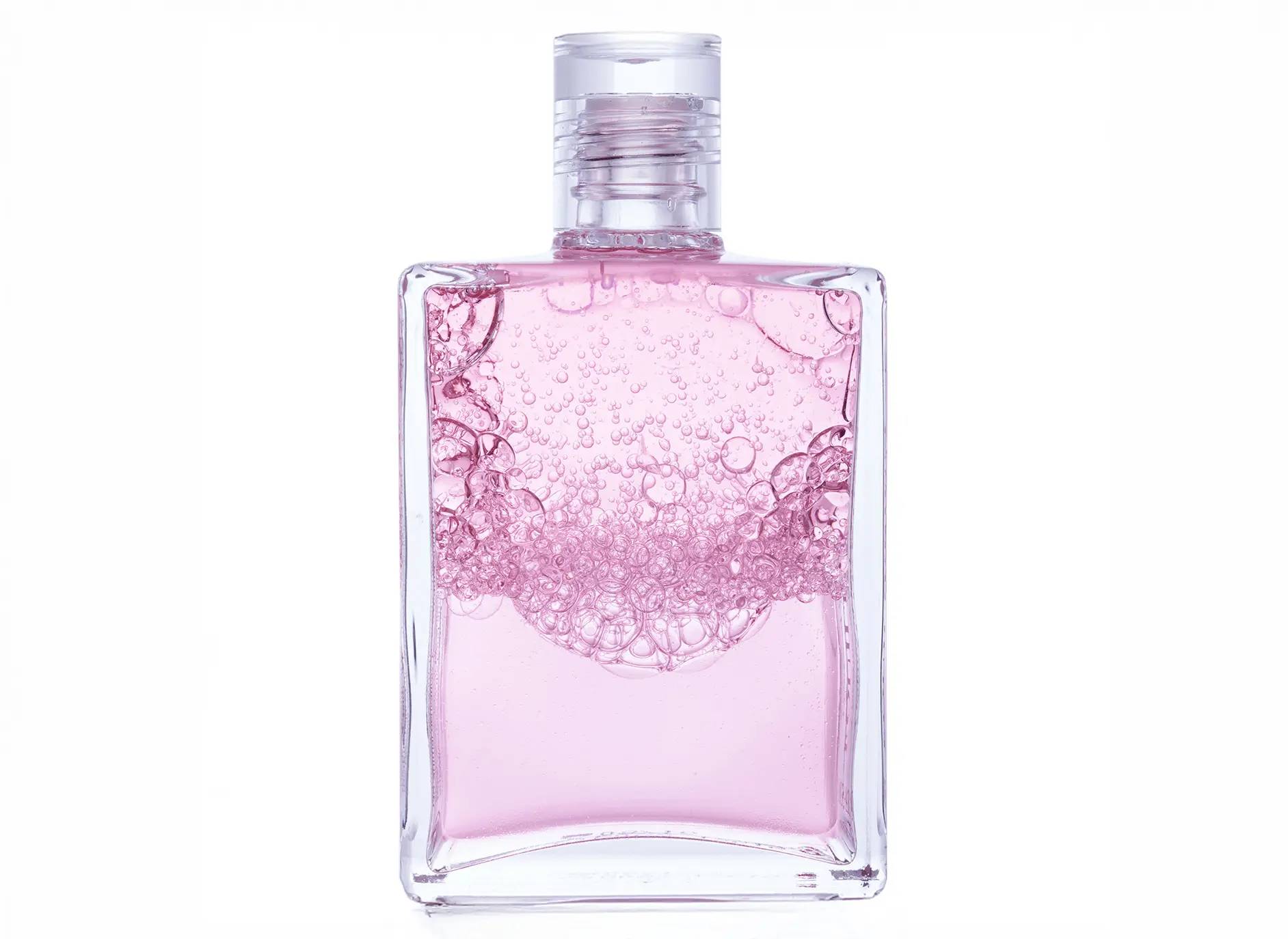 Aura-Soma Flasche Nr 52 verschüttelt so das schöne Blasenbilder zu sehen sind. Die Farbe ist Rosa über Rosa.